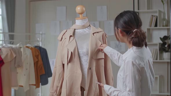 Young Asian Woman Fashion Designer Take Photo Of Clothes On Mannequin Model
