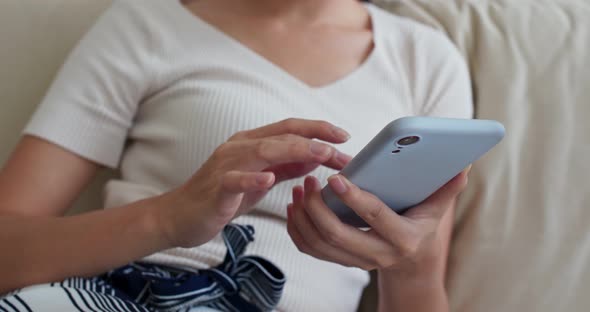 Woman use of cellphone at home