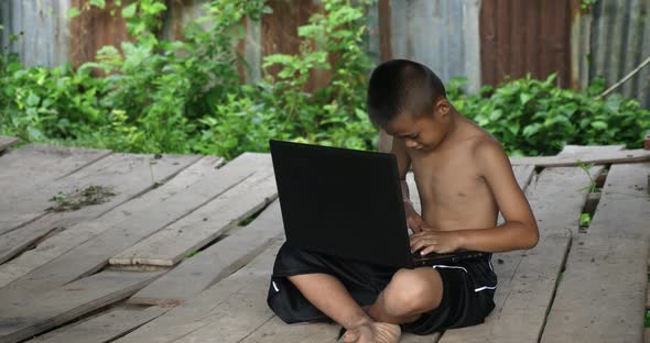 Rural Boy Using Laptop alt