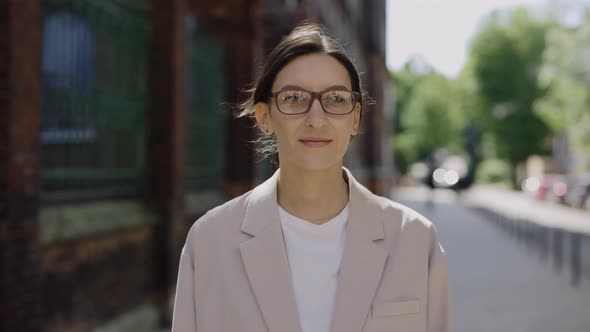 Close Up View of Pretty Business Woman in Glasses Standing Turn Around and Looking at Camera Outside