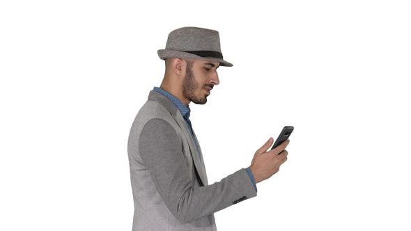 Man walking with a phone and serfing internet on white background.