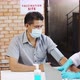Coronavirus Vaccination.Doctor syringe injection to the young patient put on a mask - VideoHive Item for Sale