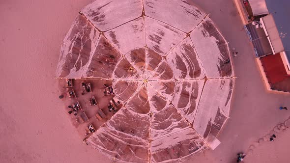 Hovering and turning down over a round structure in the beach