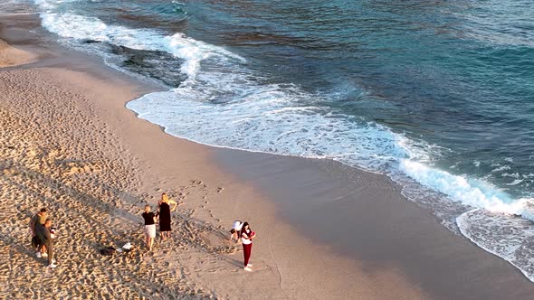 Friends play on the sea waves of the beach aerial view 4 K