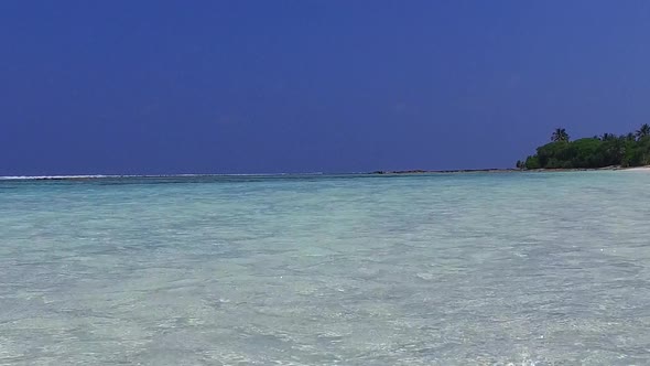 Sunny travel of shore beach by clear water with sand background after sunrise