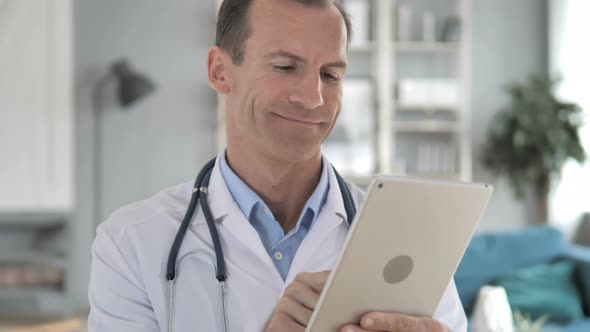 Senior Doctor Using Tablet Computer