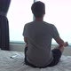 A Man Meditates on Bed While Looking Out the Window - VideoHive Item for Sale