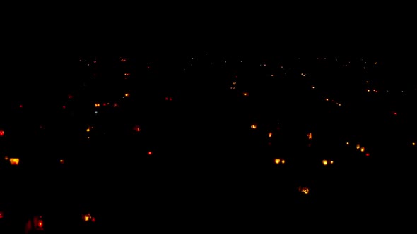 Halloween. Night cemetery with glowing lamps and burning candles
