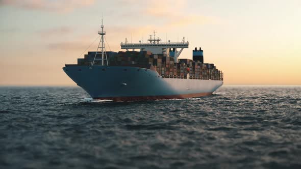 Cargo Container Ship In The Open Sea At Sunset