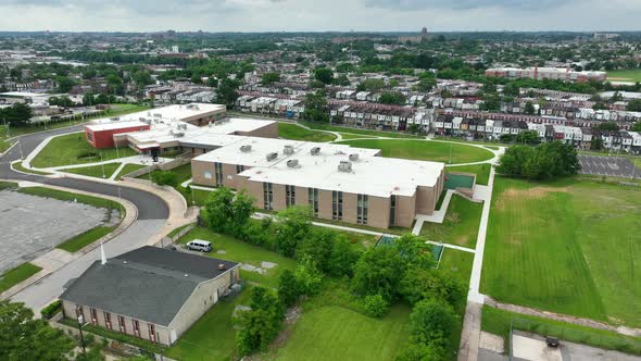 Public school in urban American setting. Housing in distance in USA. Student education in America th