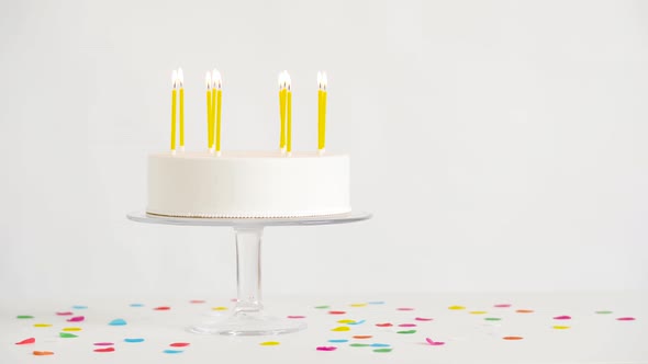 Birthday Cake with Burning Candles on Table
