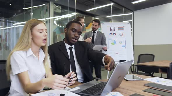 Mixed Race Business People which Working on Computer During Joint Project while Another