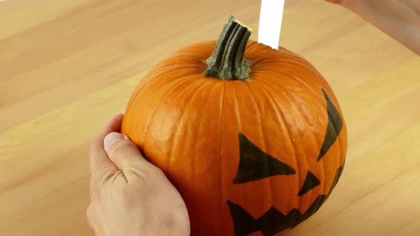 Men cleaning a pumpkin preparing her for the holiday of Halloween. Close-up of an orange pumpkin.