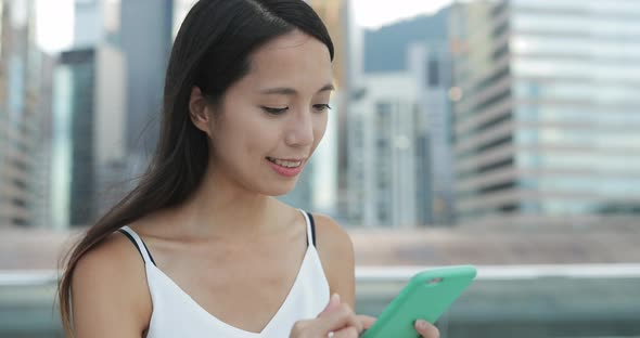 Woman use of mobile phone in the evening 