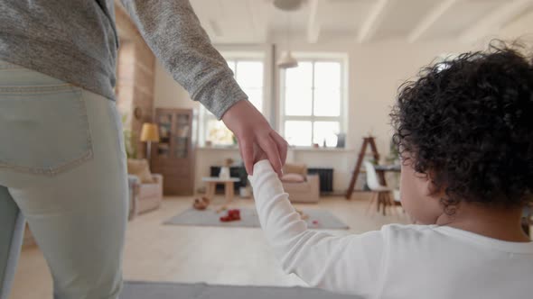 Close Up of Cute Toddler Walking with Mother at Home