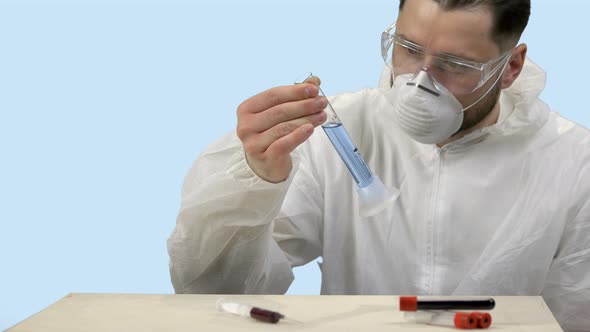 Young Scientist Shaking Test Tube with Medicine