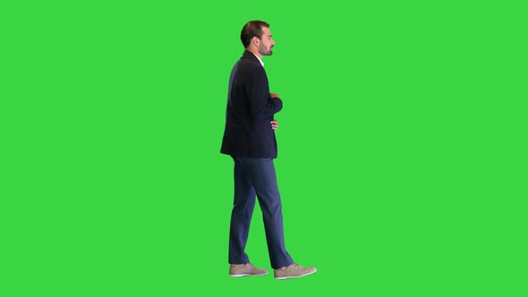 Young Businessman in Suit Talking To Camera on a Green Screen Chroma Key