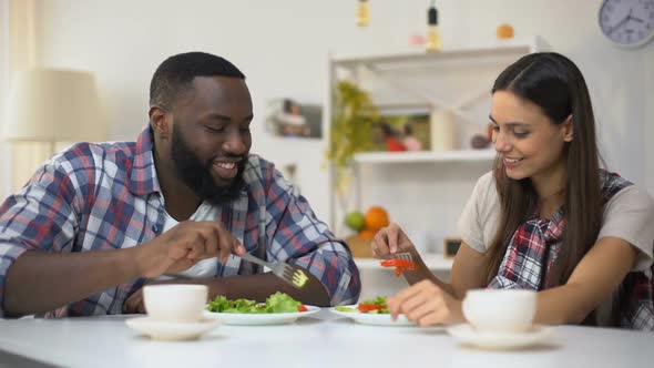 Young Mixed-Race Couple Eating Salad, Feeding Each Other, Romantic Relations