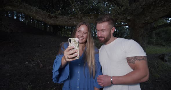 Couple with Huge Smiles Taking a Photo with Smartphone