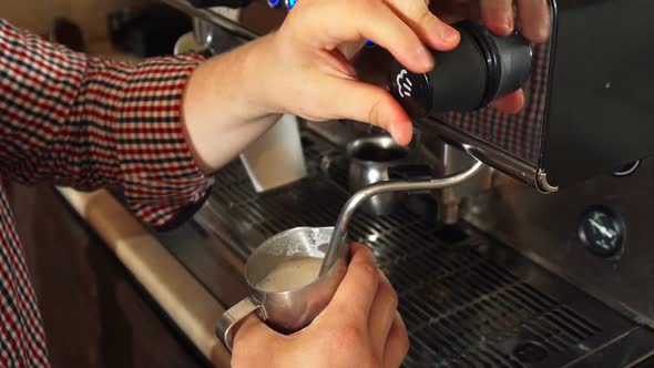 The Barista Makes Boiled Milk for Cappuccino