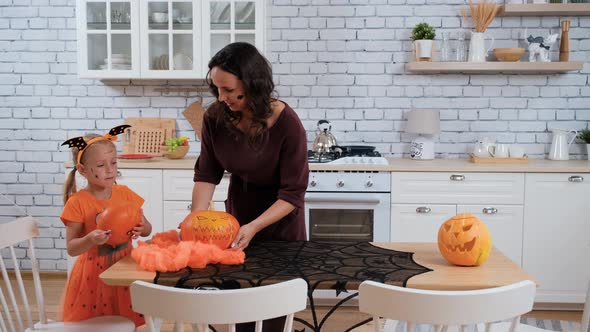 Woman with Daughter Preparing for Halloween Party