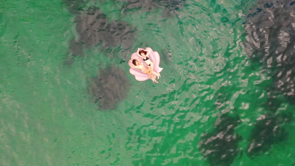Aerial view of attractive girls with an inflatable at Gordons Bay.
