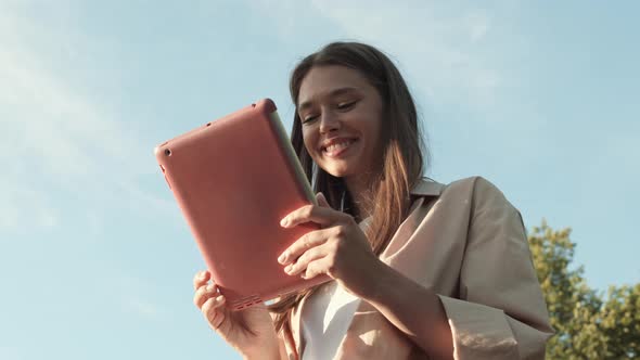 Woman Using Tablet Computer Outdoors