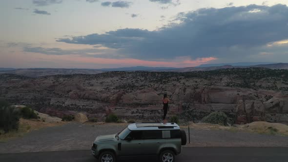 A Woman On Top Of Her Car With Camera Capturing Views From Grand Staircase-Escalante National Monume