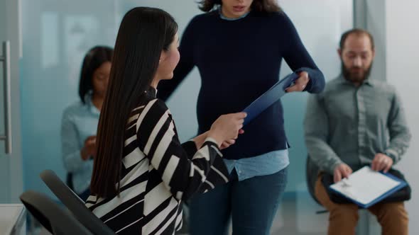 Pregnant Worker Inviting Female Applicant to Attend Job Interview