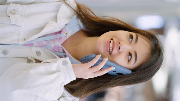 Vertical Screen Cheerful Woman Talking on Phone and Window Shopping