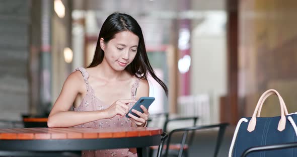 Woman use of smart phone in outdoor cafe