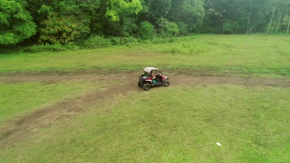 Aerial view of woman driving quadricycle on trail in Chocolate Hills Complex.