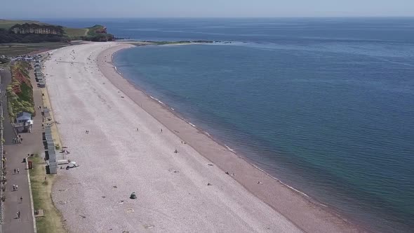 Flying out over an English beach to the ocean