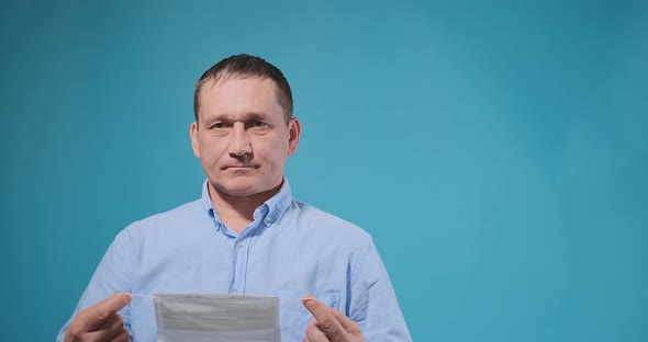 Actor Coughs Into Fist and Puts on White Disposable Mask