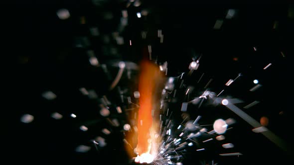 Bengal Light Burns with Sparks, Black Background, Close Up