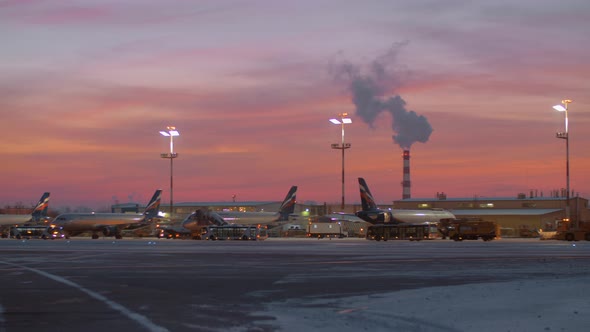 Area of Sheremetyevo Airport with planes and vehicles at the dawn in winter
