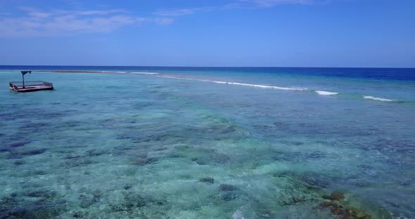 Wide angle drone island view of a white sand paradise beach and turquoise sea background in high res