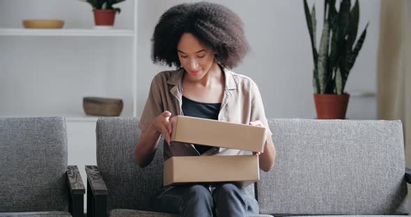 Female Buyer Receives Gift From Online Store, Order From Delivery Service, Unpacks Goods, Happily