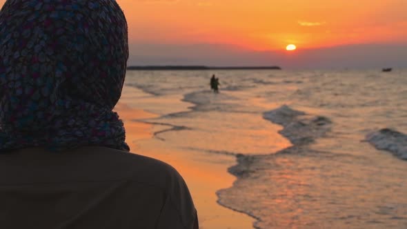 Muslim Stand In Beach Watch Sunset