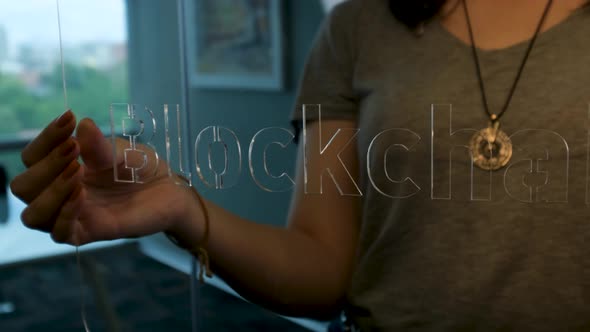 Woman Holding Glass Blockchain Sign