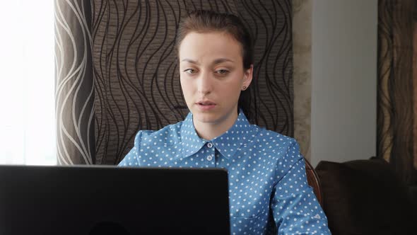 Young Woman Talking to People in Video Chat Using Laptop