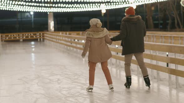 Couple Ice-Skating Outdoors