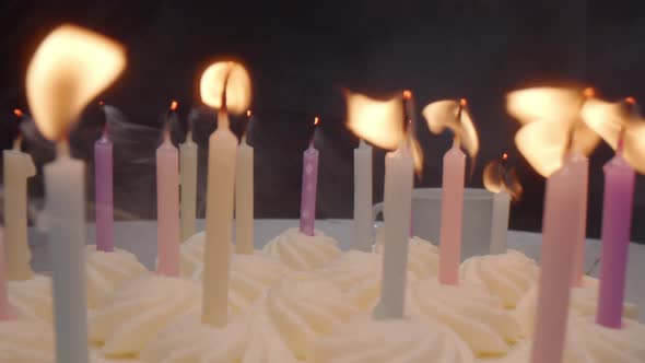 Candles on Birthday Cake Being Blown Out