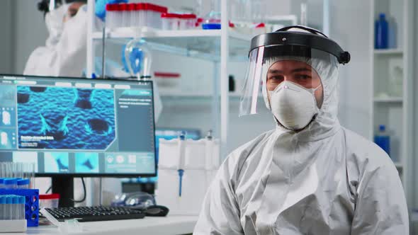 Doctor in Protection Suit Looking Exhausted at Camera