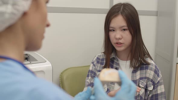 Asian Girl Having Appointment with Orthodontist