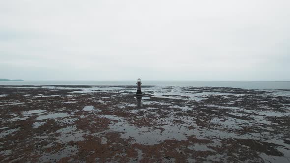 AERIAL: Low slow fly towards Whiteford Lighthouse at low tide, Whiteford, 4k Drone