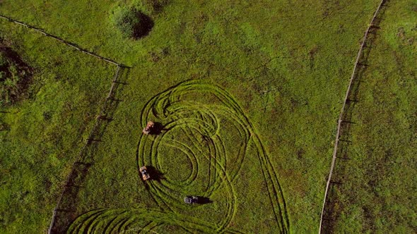 Aerial View of Young Men Riding Atv Bikes on Green Meadow