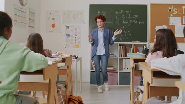 Woman Teaching Math to Kids in Middle School