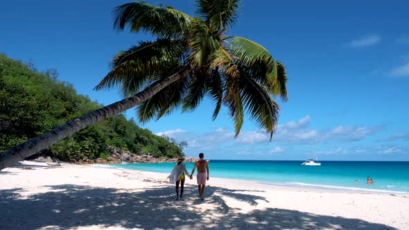 Anse Georgette Praslin Seychelles Young Couple Men and Woman on a Tropical Beach During a Luxury