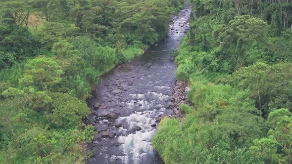 River through tropical rainforest at Arenal Volcano National Park, Costa Rica. Aerial drone view